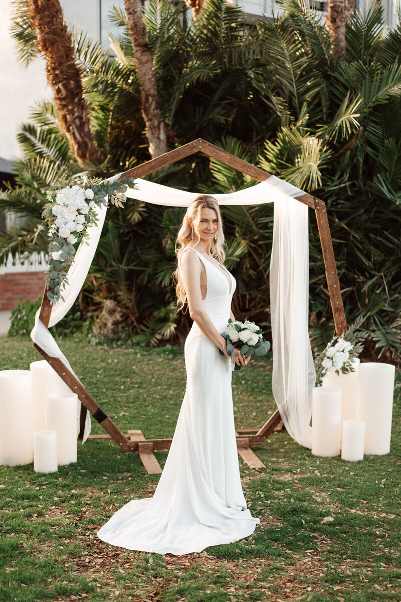 Flameless candles by a wedding arch at a micro-wedding in San Diego