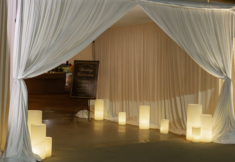 Guest Entrance Tunnel Decorated With Drapery and Oversized Candles
